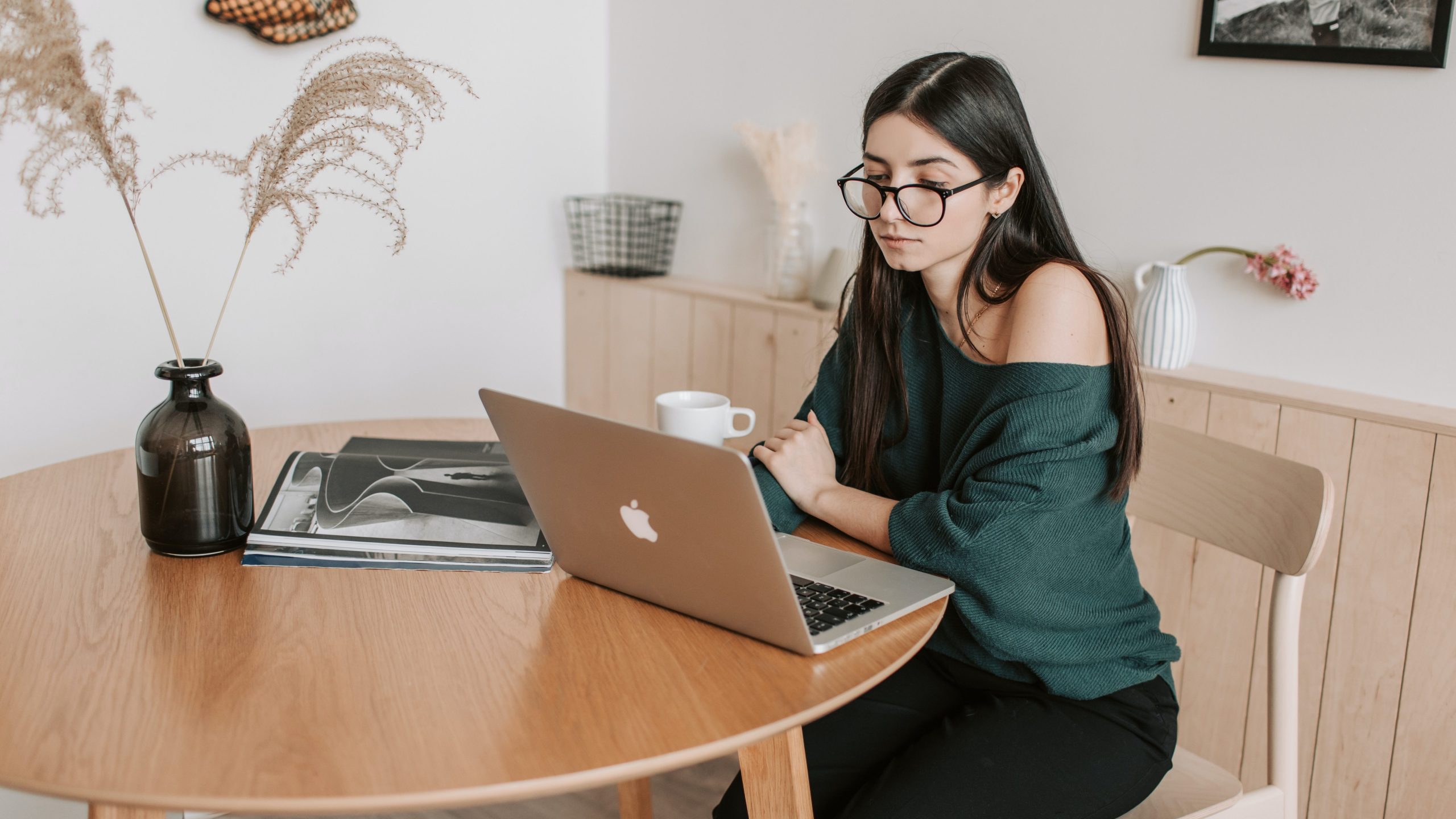 A White woman working on her computer.