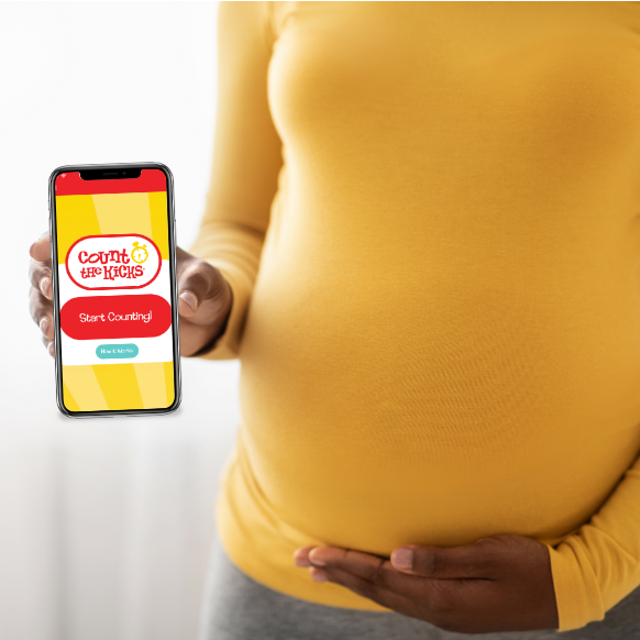 Pregnant woman holding phone with CTK App on Screen
