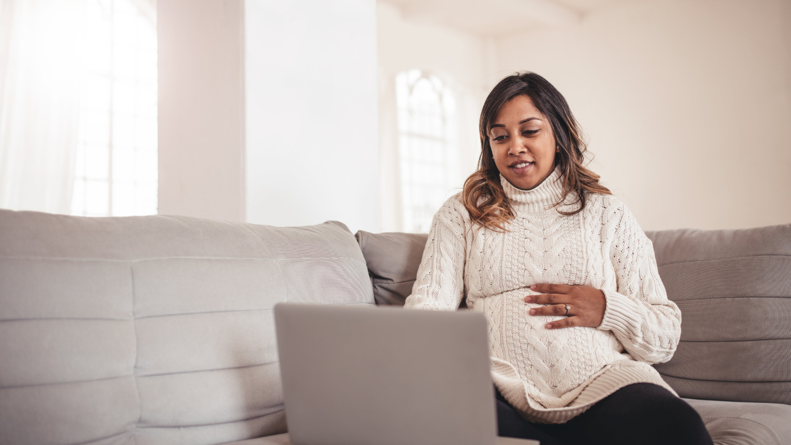 A pregnant mom using her laptop.