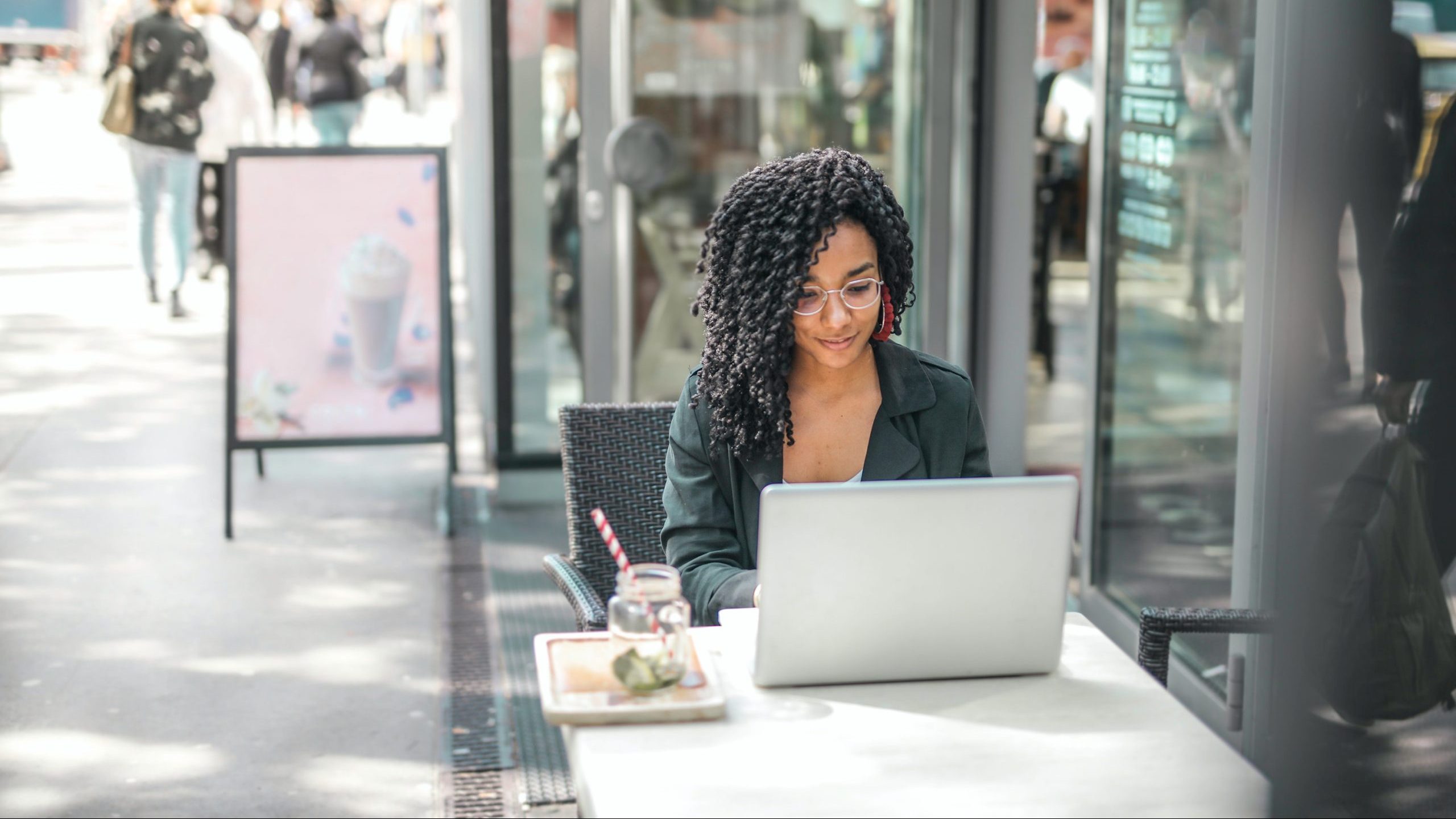 Woman working on computer at patio table